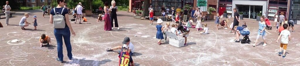 children drawing with chalk