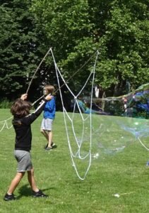A child making giant bubbles